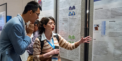 COMSOL Conference attendees and poster presentations in the conference's poster hall.